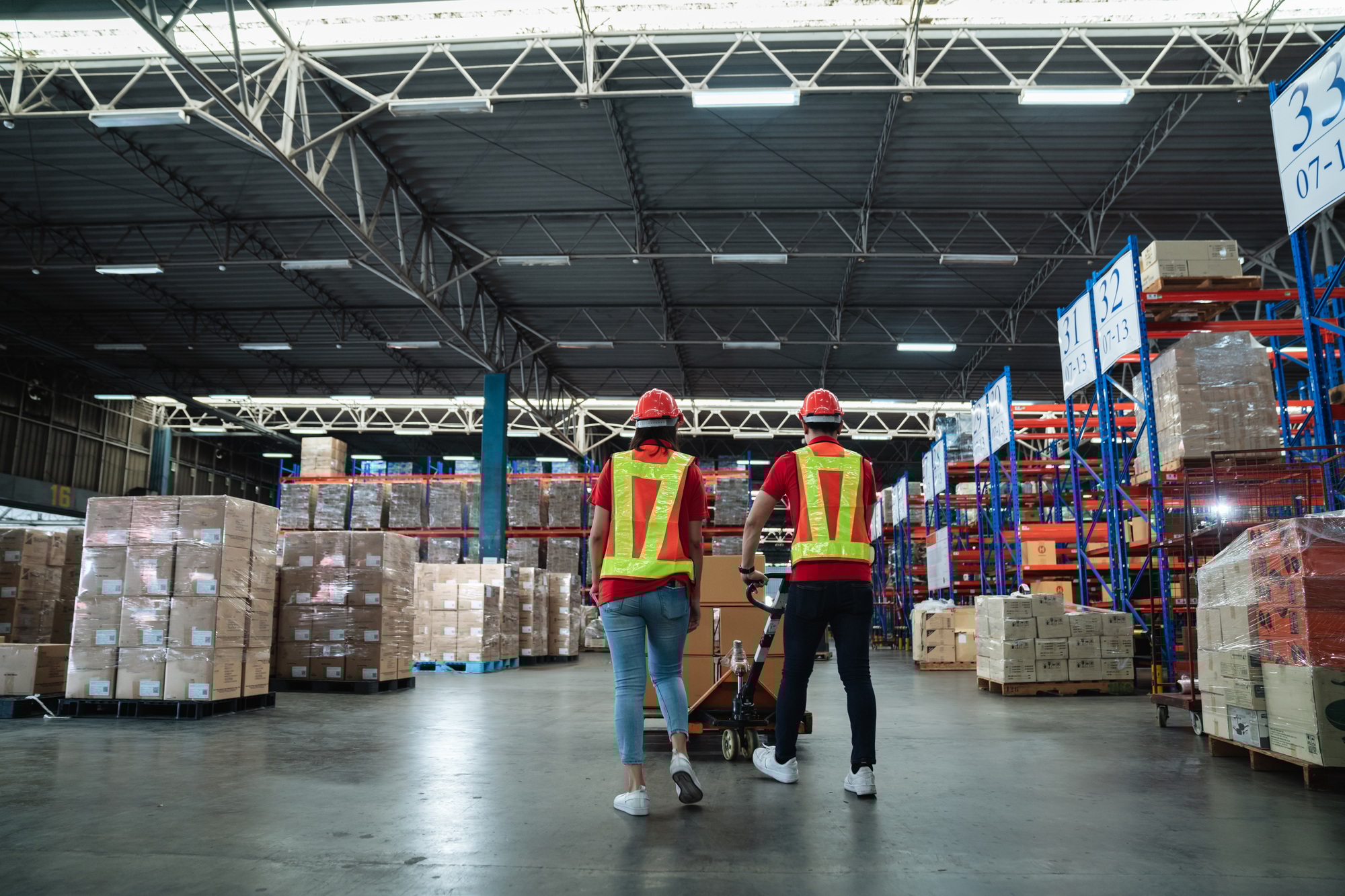 Warehouse workers walking to check details stock product and moving goods and counting stock.