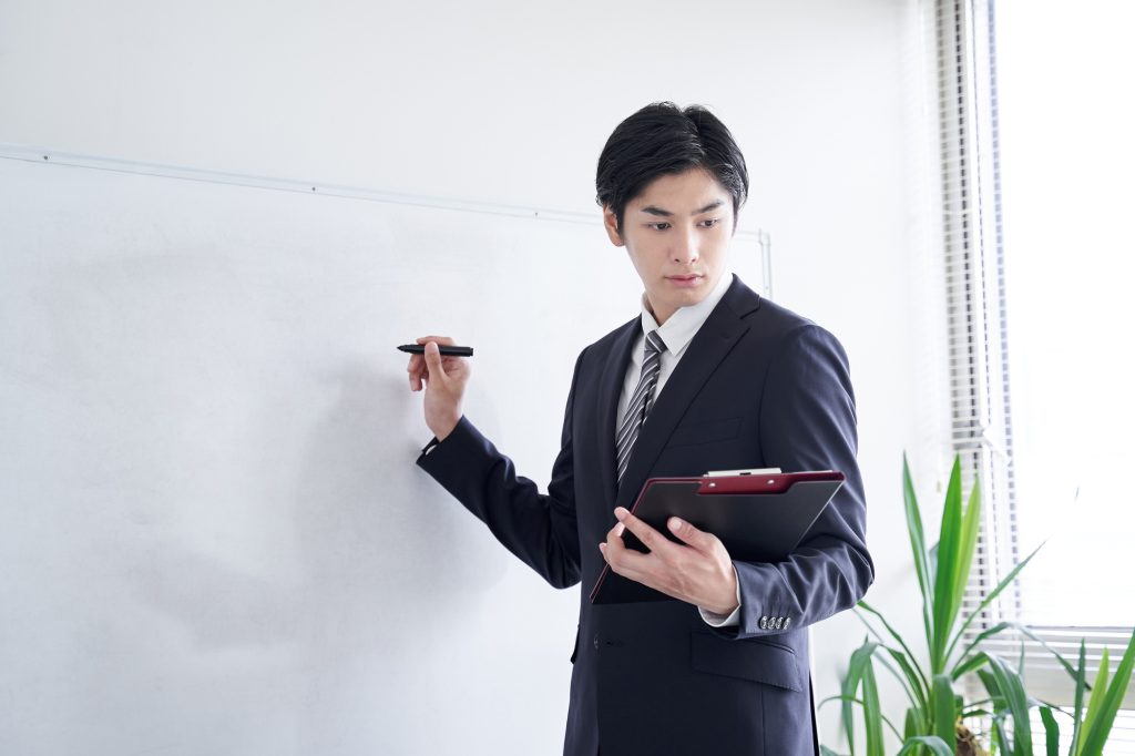 A Japanese male businessman practicing his presentation