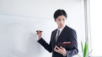 A Japanese male businessman practicing his presentation