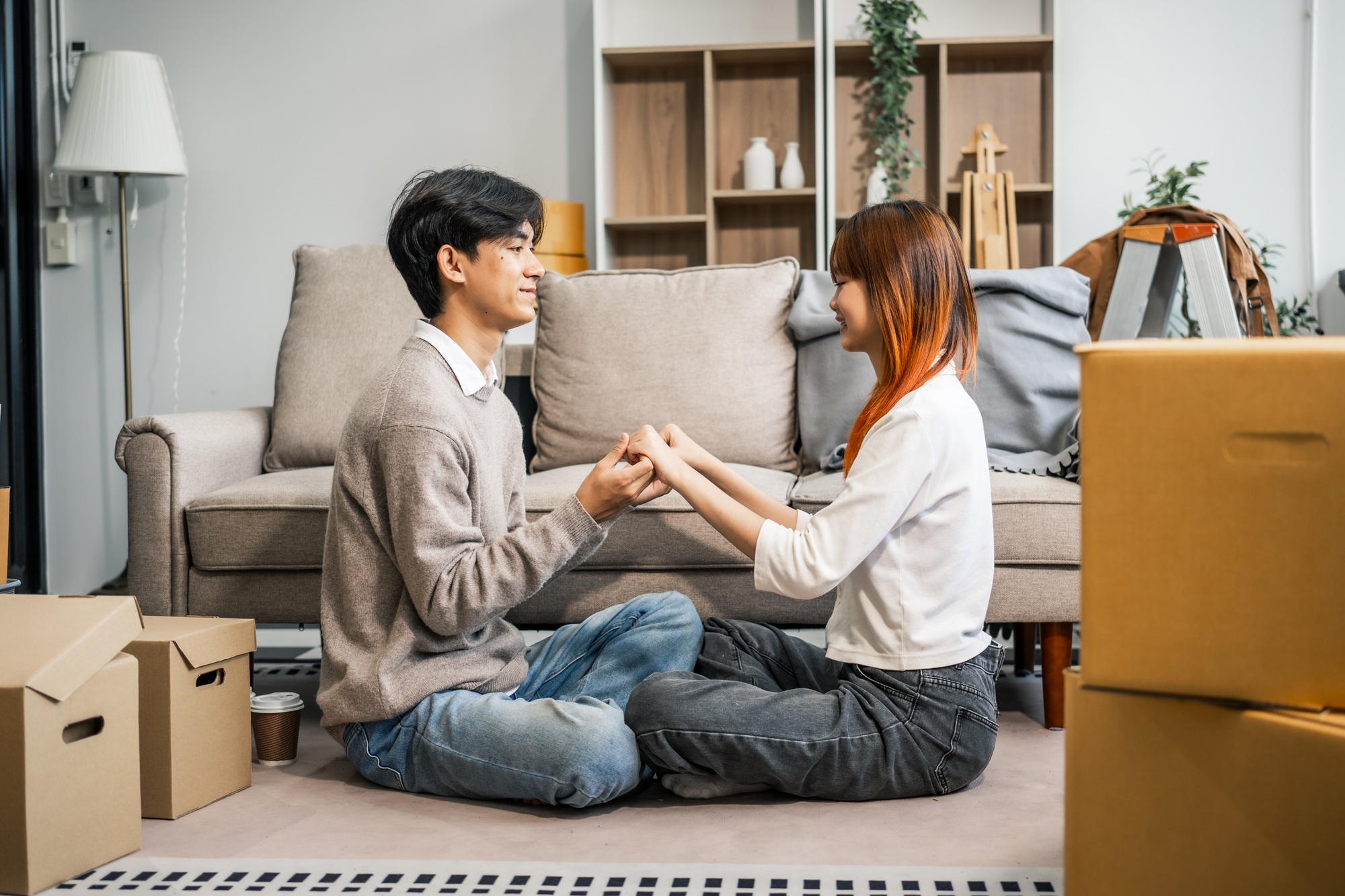 A stressed young couple faces financial challenges, struggling with debt and bills. Despite the