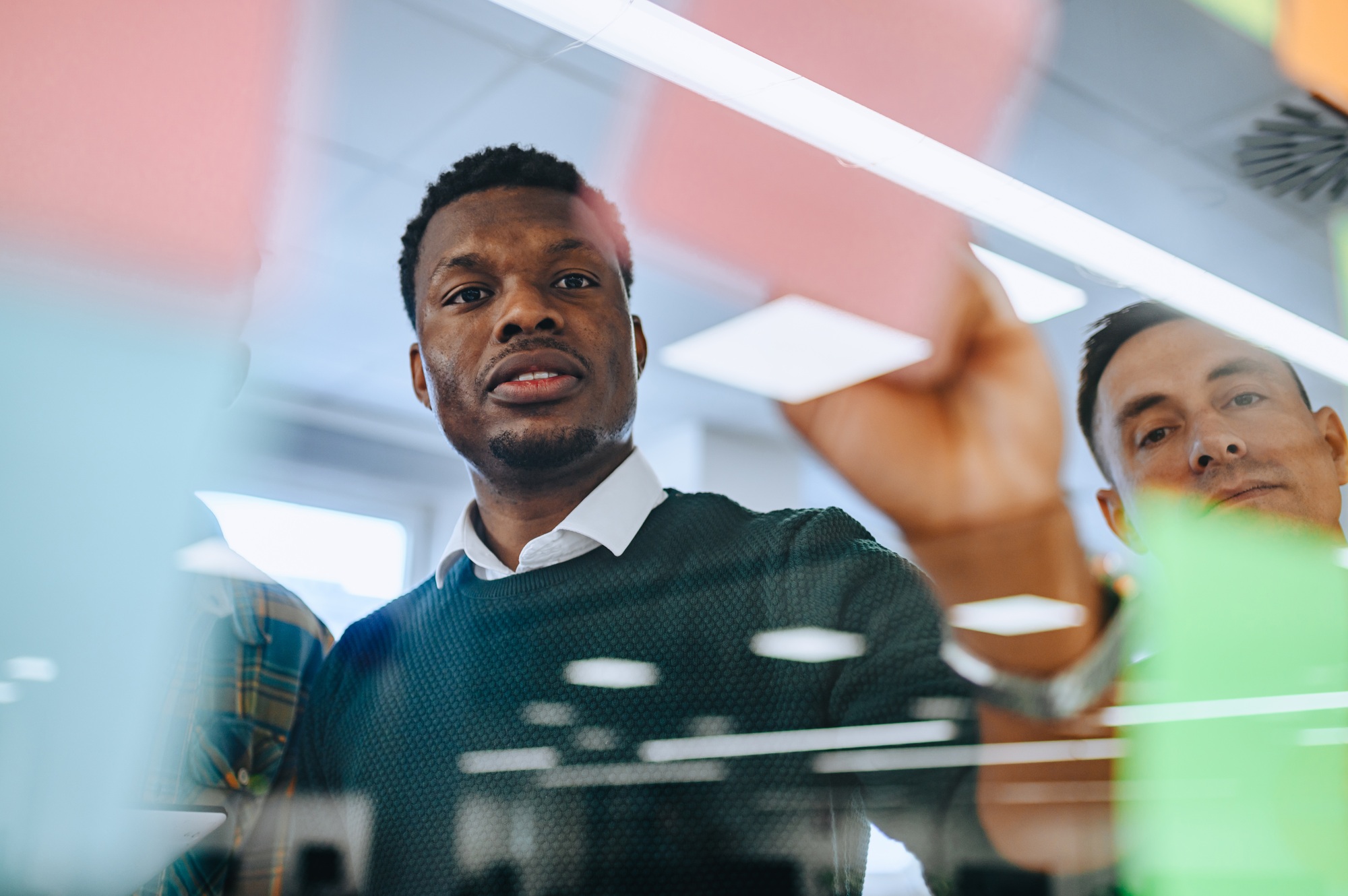 African american young businessman writing his ideas on a sticky notes