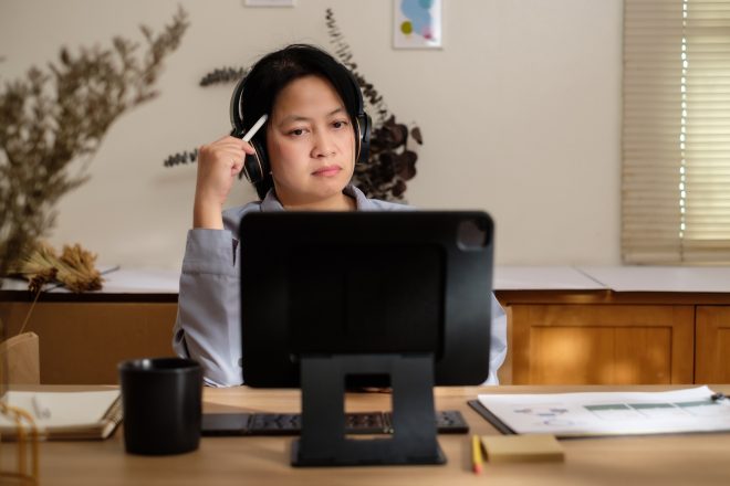 asian woman planning business goal using tablet at home