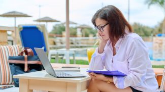 Beautiful business woman in her 40s working on a laptop remotely