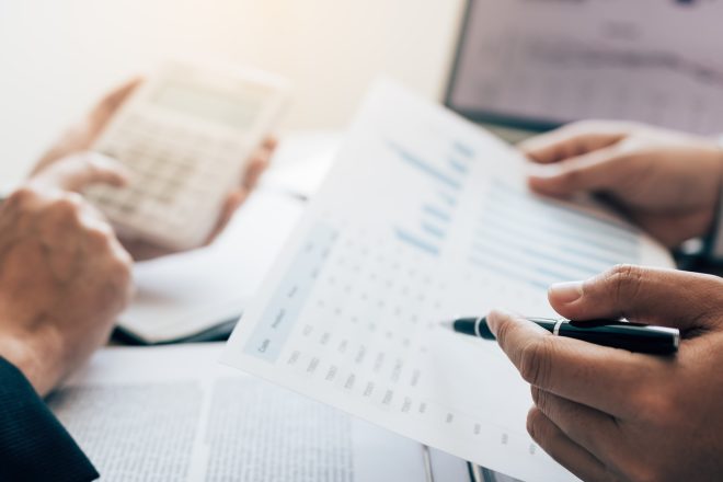 Business people pointing on statistic number result and analysis finance cost