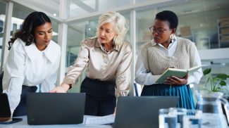 Business women, meeting or discussion with laptop for project management, planning or collaboration