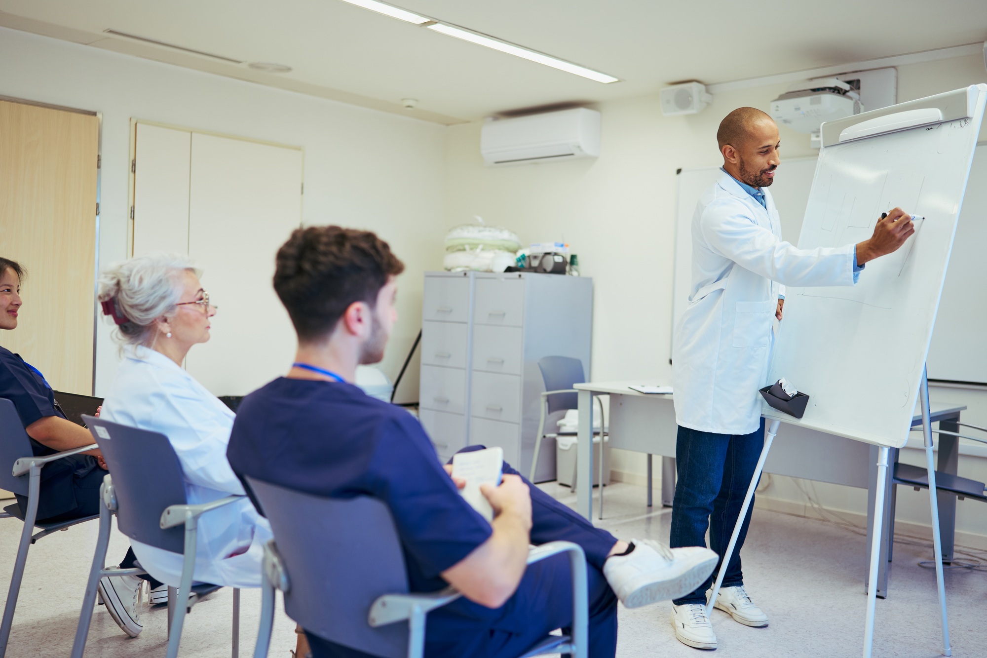 Doctor giving a lecture to medical staff in hospital meeting room