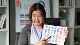 Graphic designer presenting color swatches for branding and visual identity