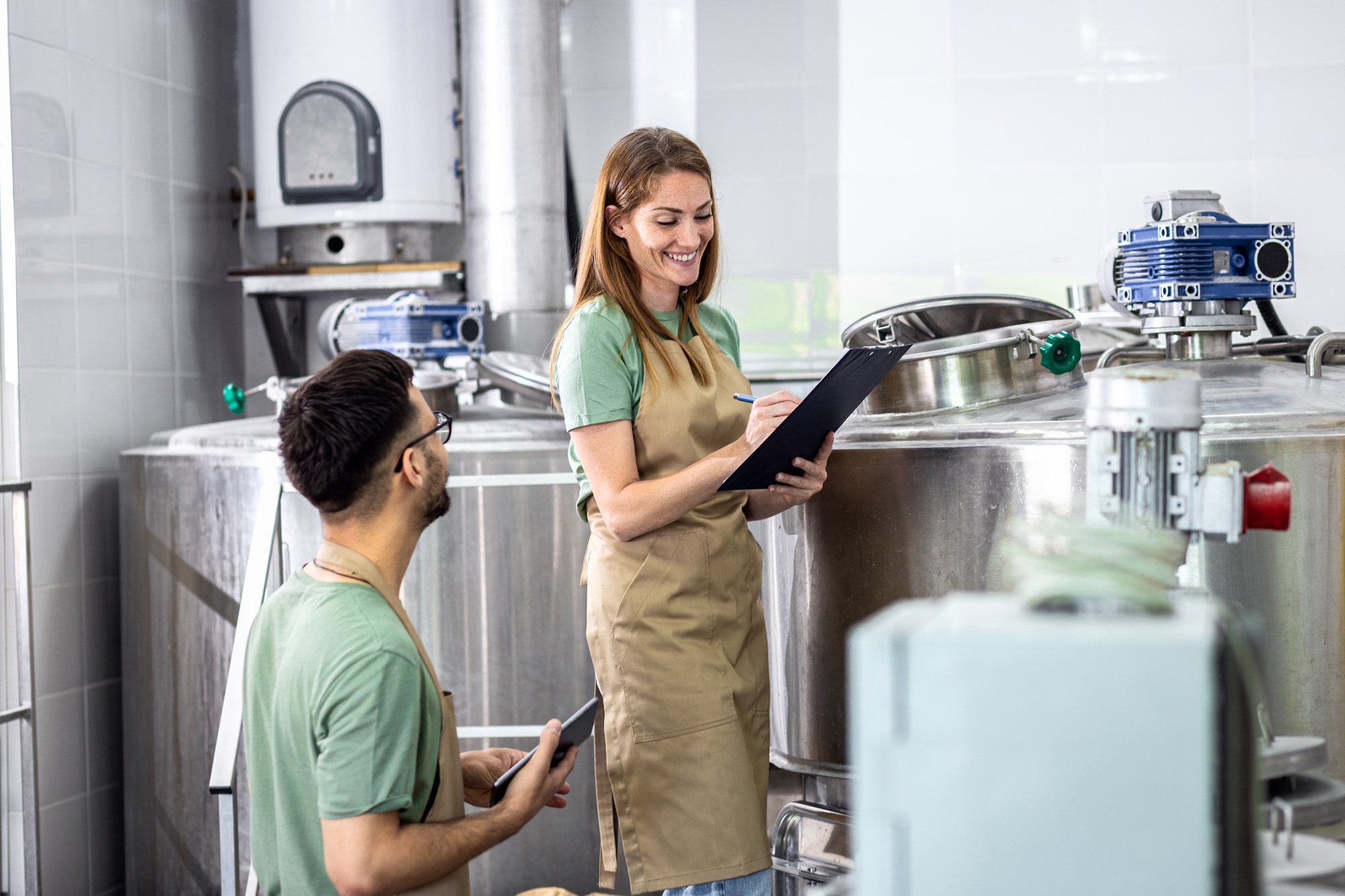 Man and woman working in craft brewery.