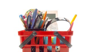 Multiple office tools in a shopping cart, isolated on white background