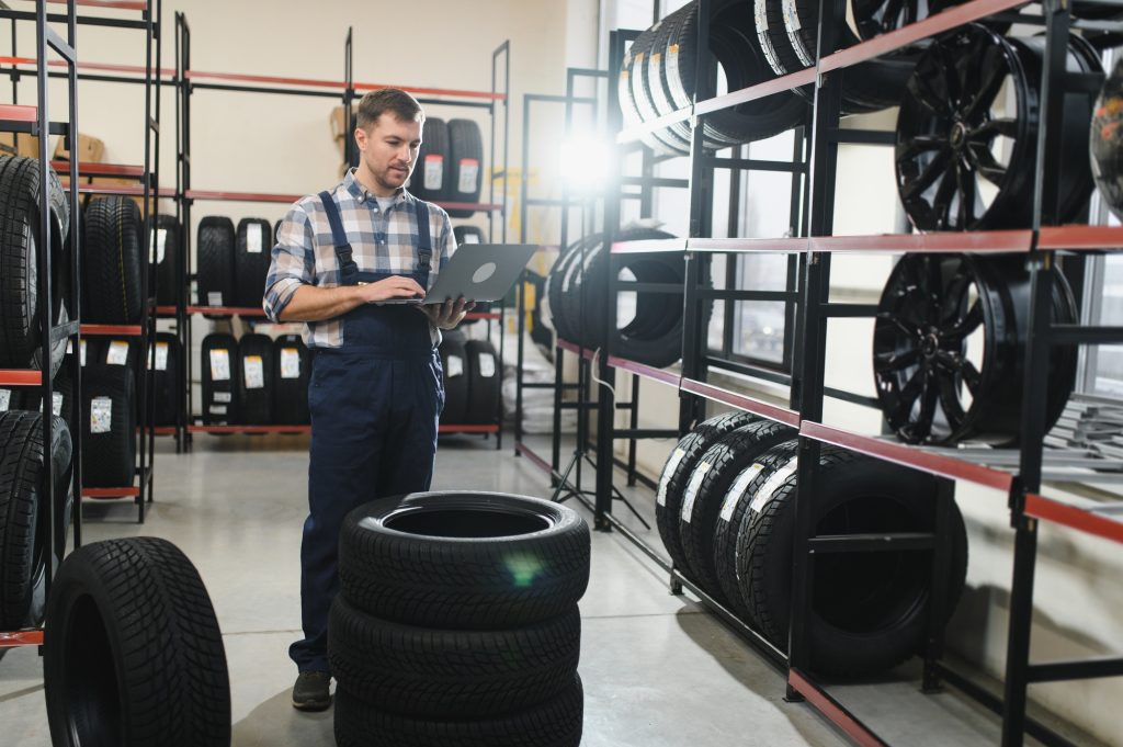 Portrait of a worker in a new car tire shop. Concept of changing tires