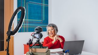 Senior lady recording a tutorial video.