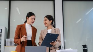 Team of businesswomen analyzing financial charts, planning company growth.