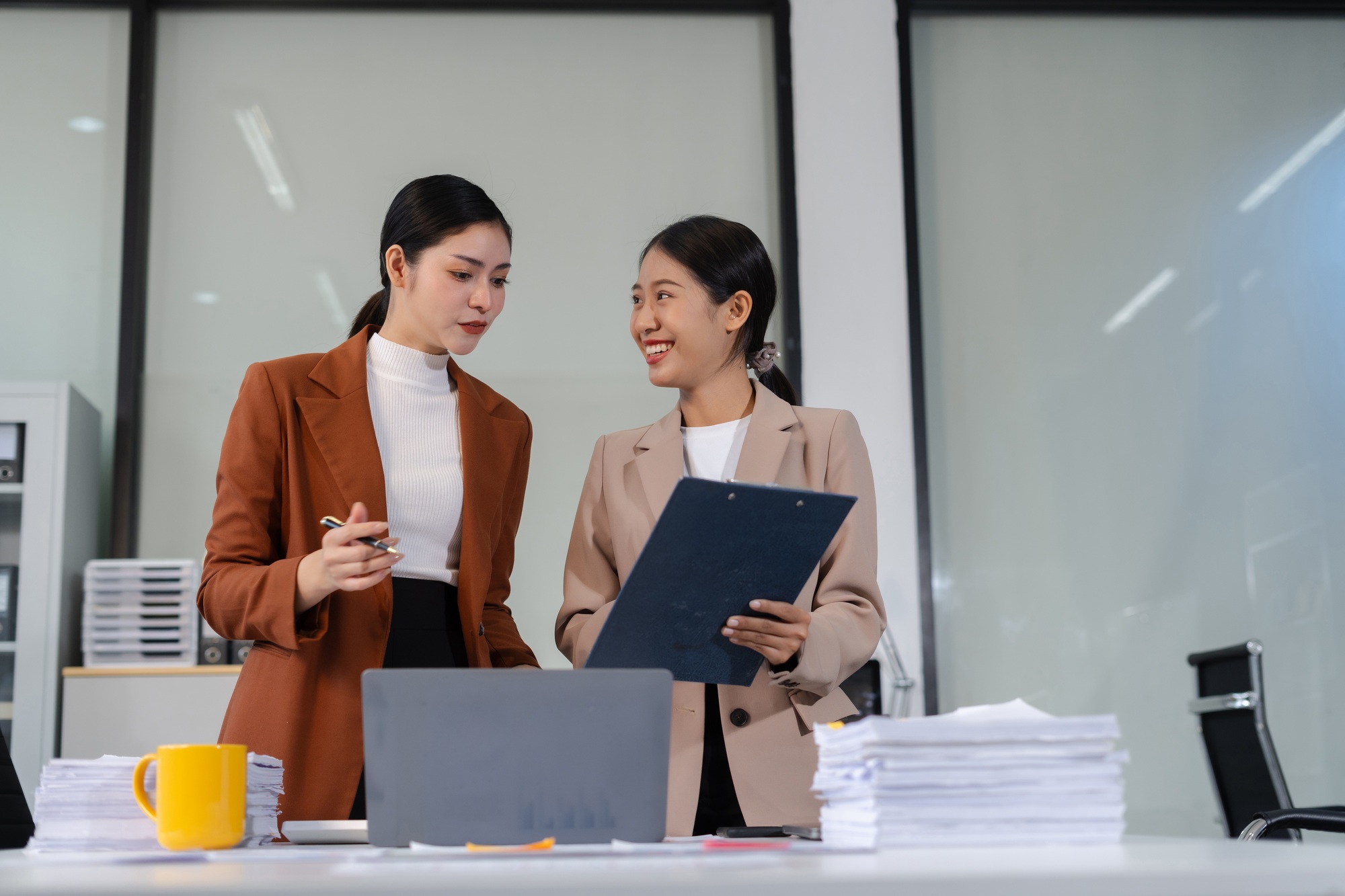Team of businesswomen analyzing financial charts, planning company growth.