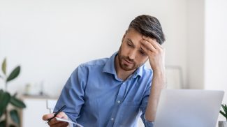 Tight Schedule. Tired Businessman Checking Business Appointments In Notepad At Office