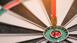 The red arrow in the middle of the dart board shown success. The concept of setting business goals