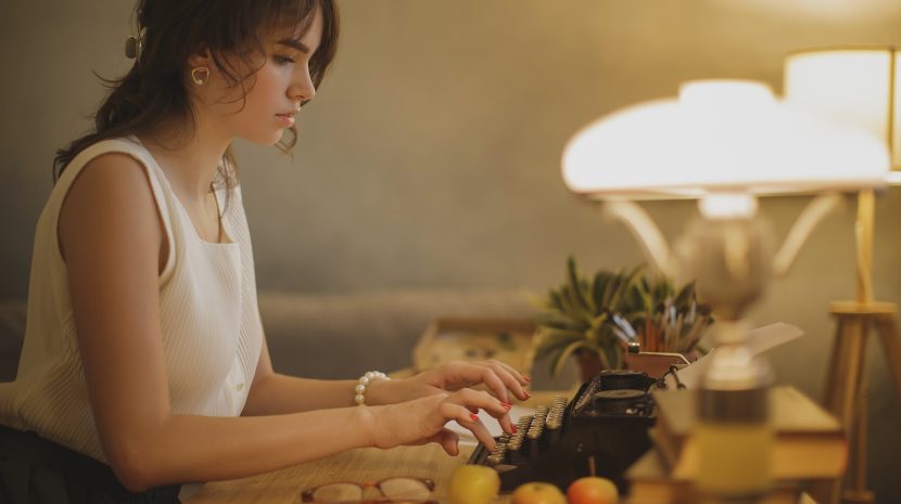 Woman Writer Working on a Typewriter