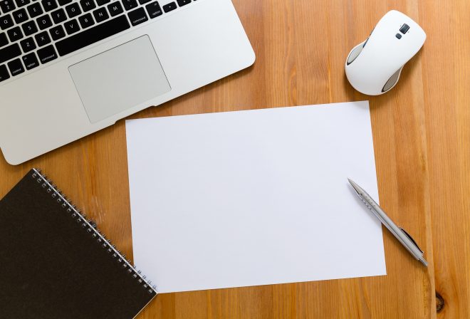 Working desk with laptop computer blank paper for advertising