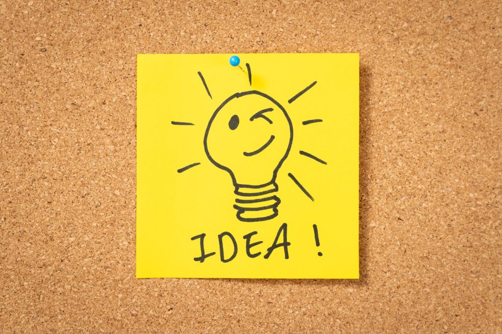 yellow sticker note with lightbulb and idea message